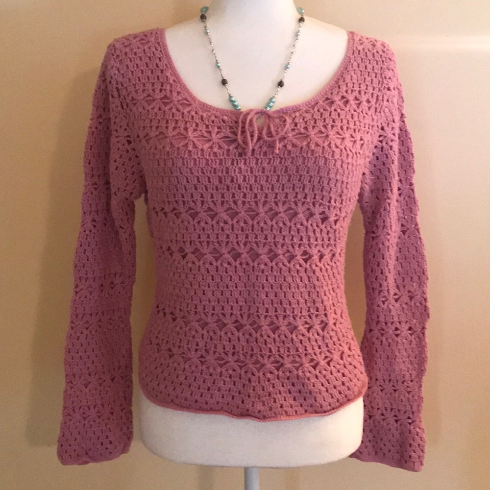 Adorable pink sweater.